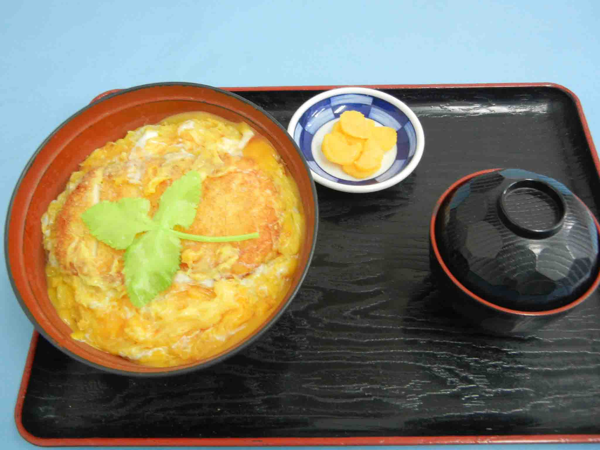 Donburi Bowl of Rice Topped with Pork Cutlet, Eggs, and Onions