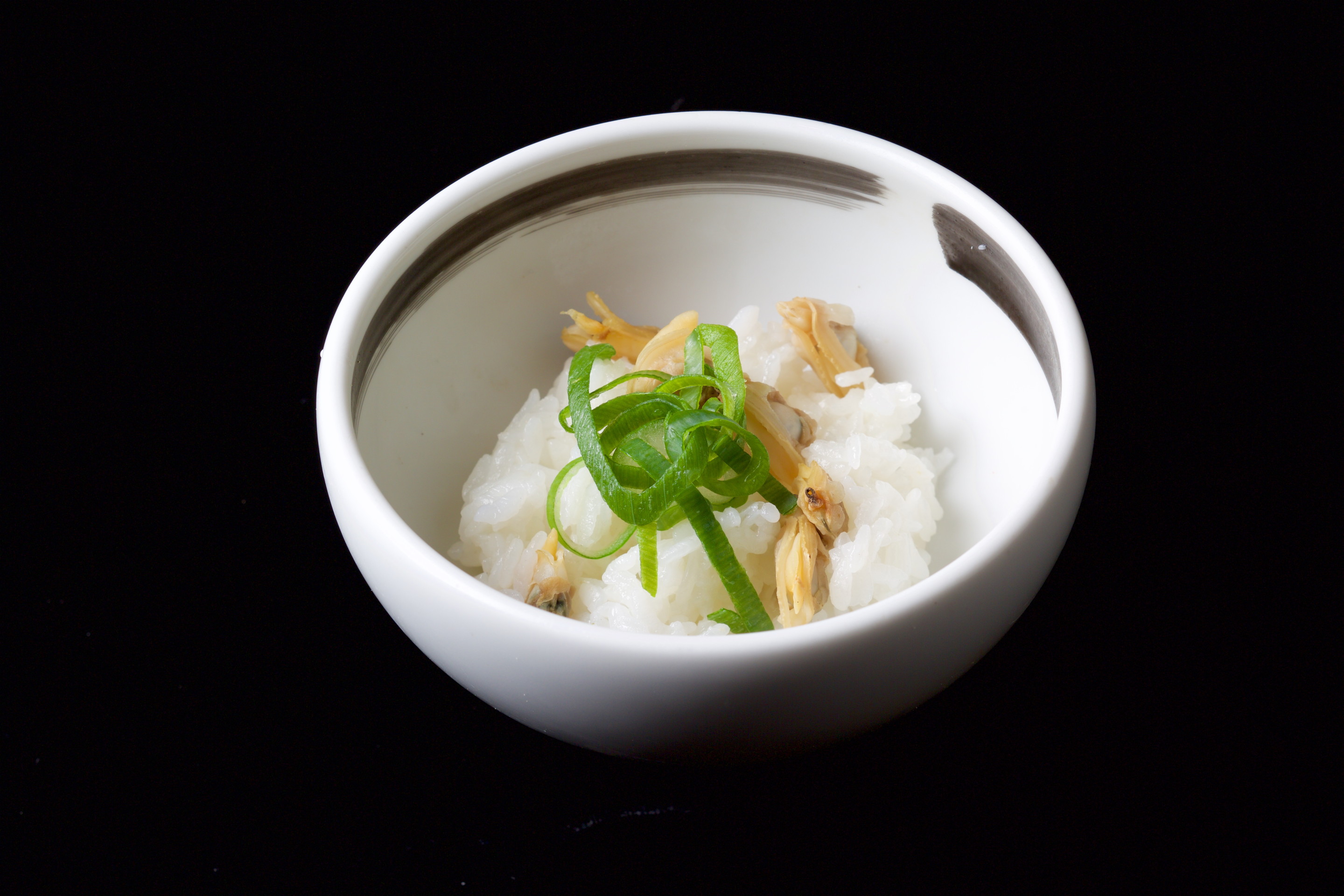 A mouthful of Rice and Asari (Japanese Littleneck) Steamed Together